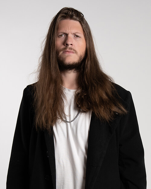 Alex standing and looking at camera